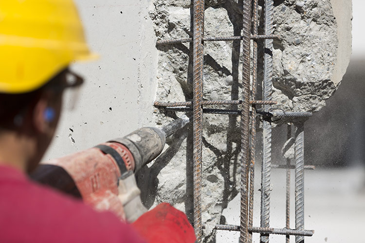Construction worker using a drilling power tool